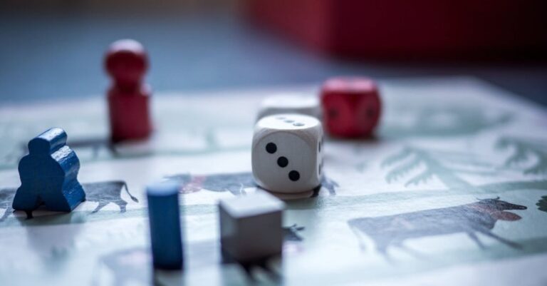 Games - Dices and Wooden Pieces on Game Board