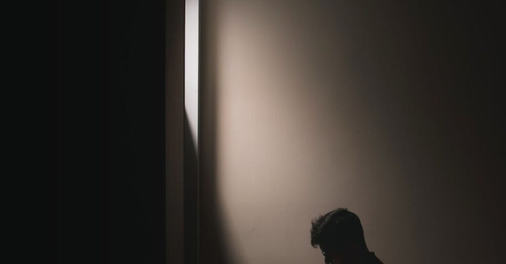 Book - A Man Reading Book while Sitting on a Bed