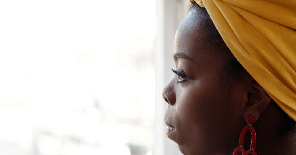 Traditions - Photo Of Woman Looking Through Window